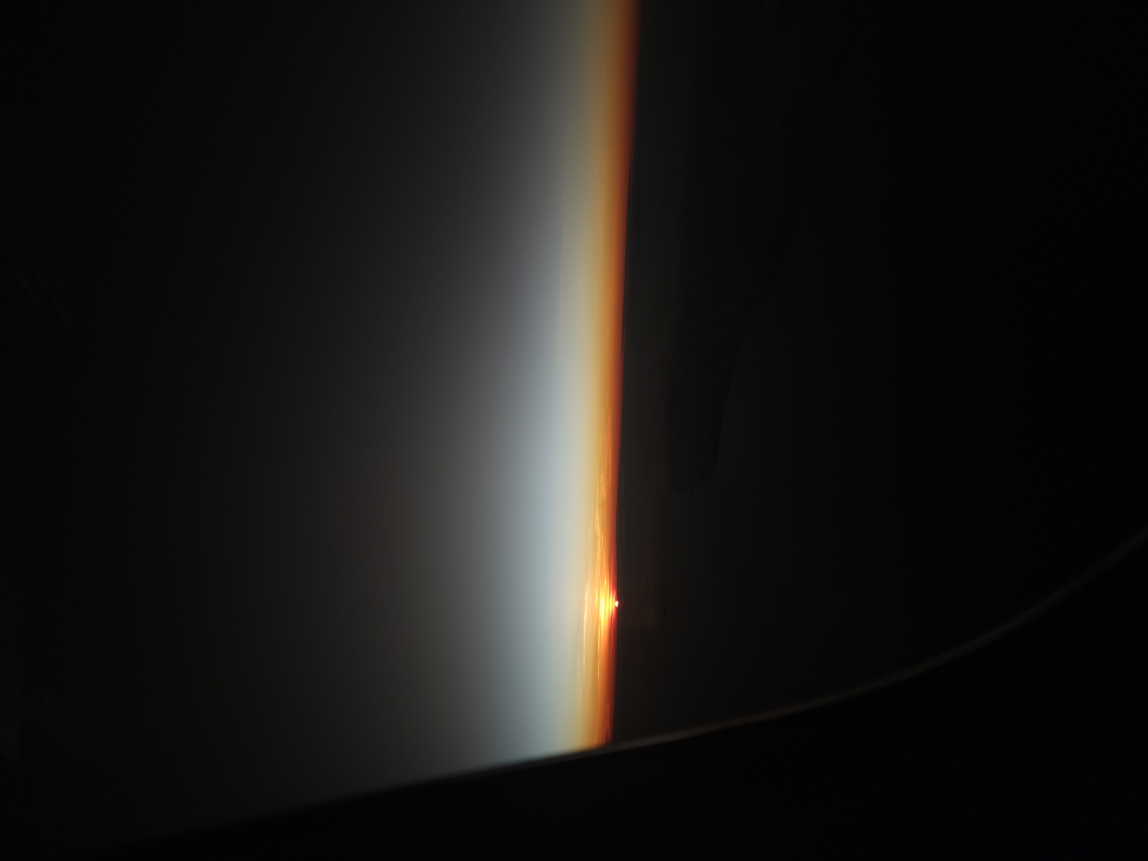 The first edge of sunrise seen through an aeroplane window